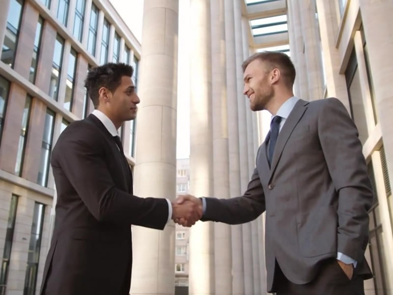 Two people shaking hands after a press release marketing deal. Professional Services